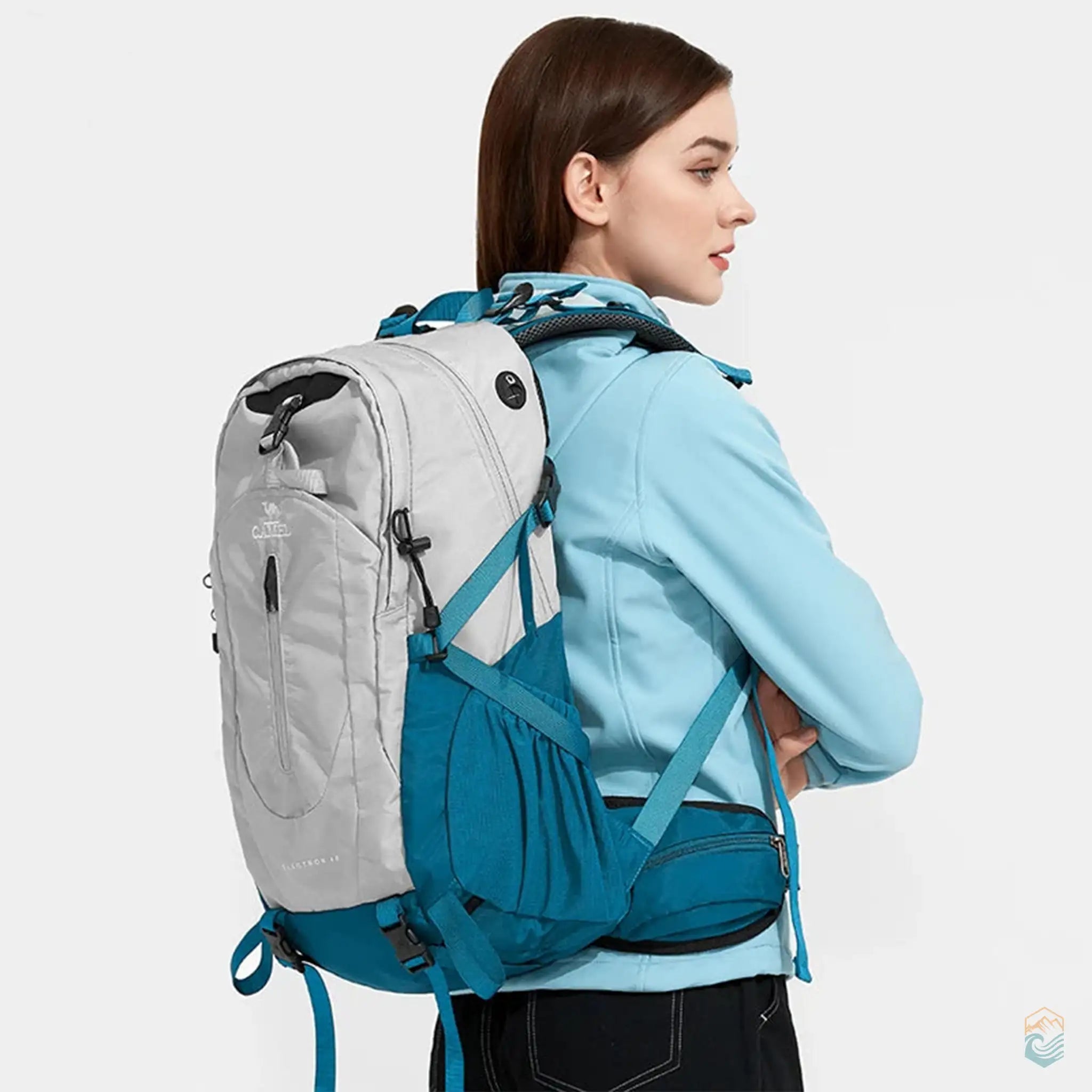 Model wearing an aqua gray Camel 40L waterproof hiking backpack, showing a side profile view with ergonomic straps and a secure fit, ideal for hiking and outdoor activities.