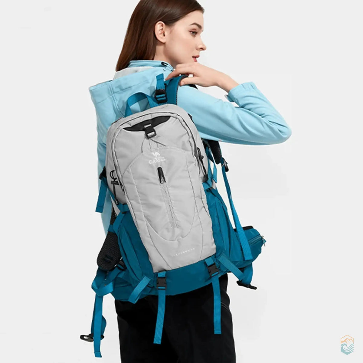 Model wearing an aqua gray Camel 40L waterproof hiking backpack, highlighting its adjustable straps and ergonomic fit, perfect for outdoor adventures and daily hikes.