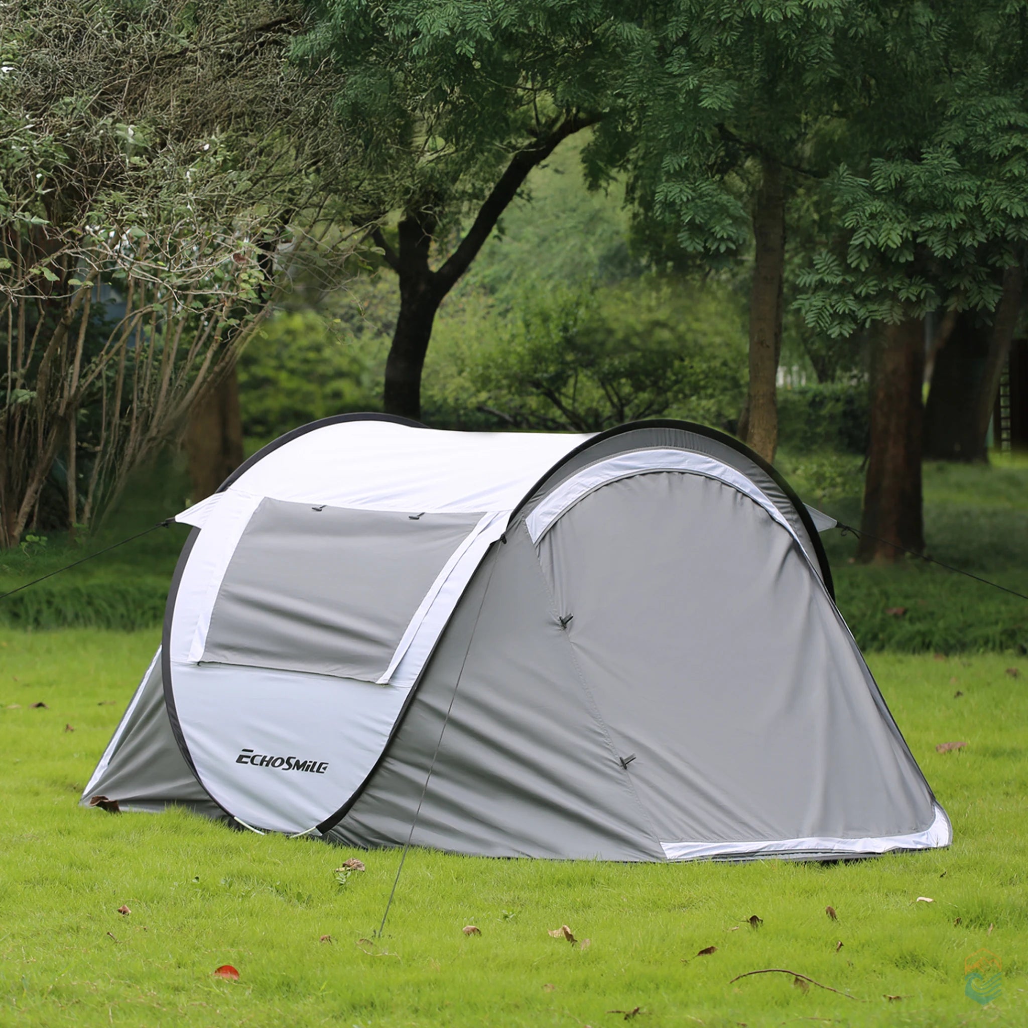 EchoSmile 5-person pop-up camping tent pitched in a forest clearing, side view showing zippered window cover and aerodynamic profile for weather resistance