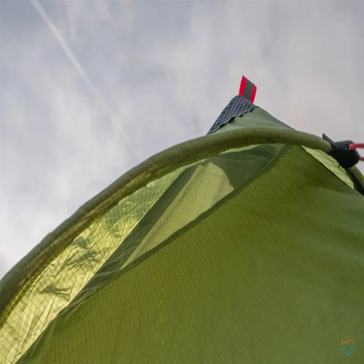 Close-up of the ventilation flap and reinforced stitching on the FLAME'S CREED Lanshan 2 Pro green tent, showcasing mesh airflow design and durable materials under an open sky.
