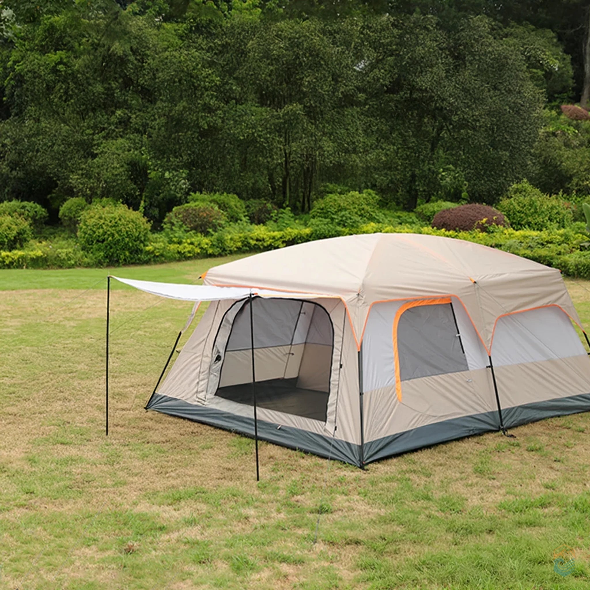 Khaki Sonuto family camping tent set up on grass with extended canopy and two-room design, surrounded by trees and nature