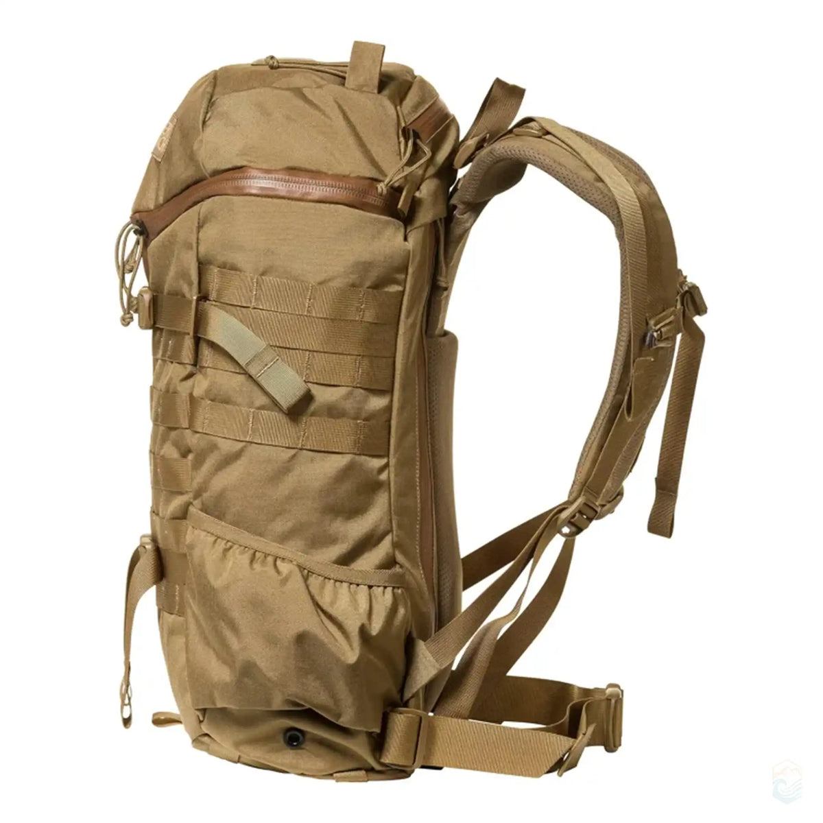 Side view of the tan Mystery Ranch hiking backpack, showcasing the ergonomic shoulder straps, adjustable waist belt, and MOLLE system for additional gear attachment. The durable fabric and compact design make it ideal for outdoor adventures.