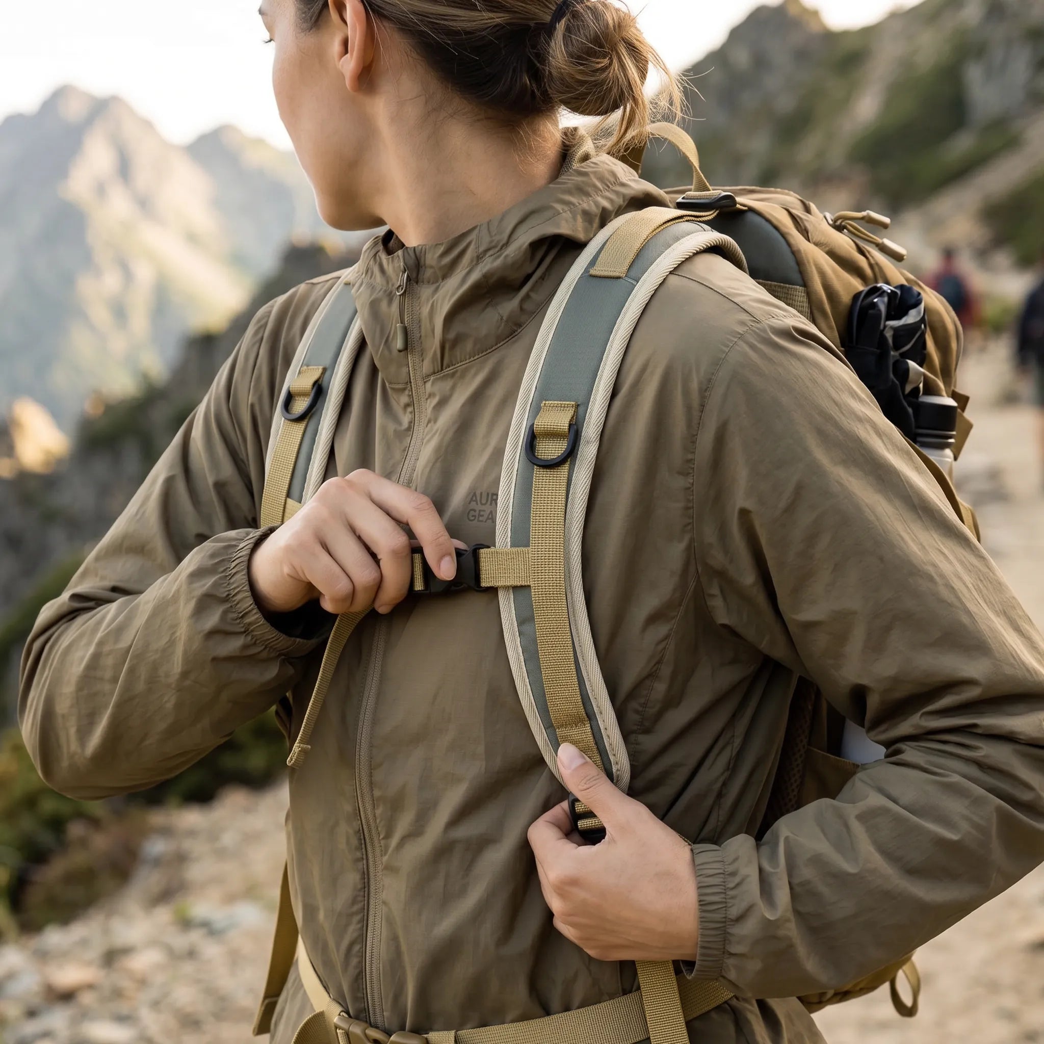 Woman adjusting the chest strap of a BISINNA 22L hiking backpack while hiking on a mountain trail.