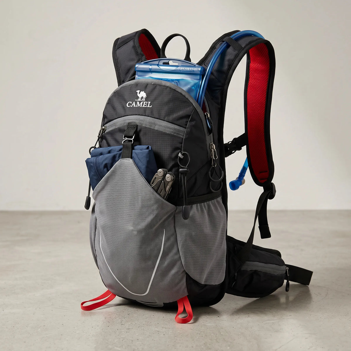 Camel 12L hiking backpack in black with hydration reservoir, lightweight waterproof construction, breathable padded shoulder straps, front mesh storage pocket, and 12L capacity for hiking, trekking, camping, cycling, trail running, travel, and outdoor adventures.