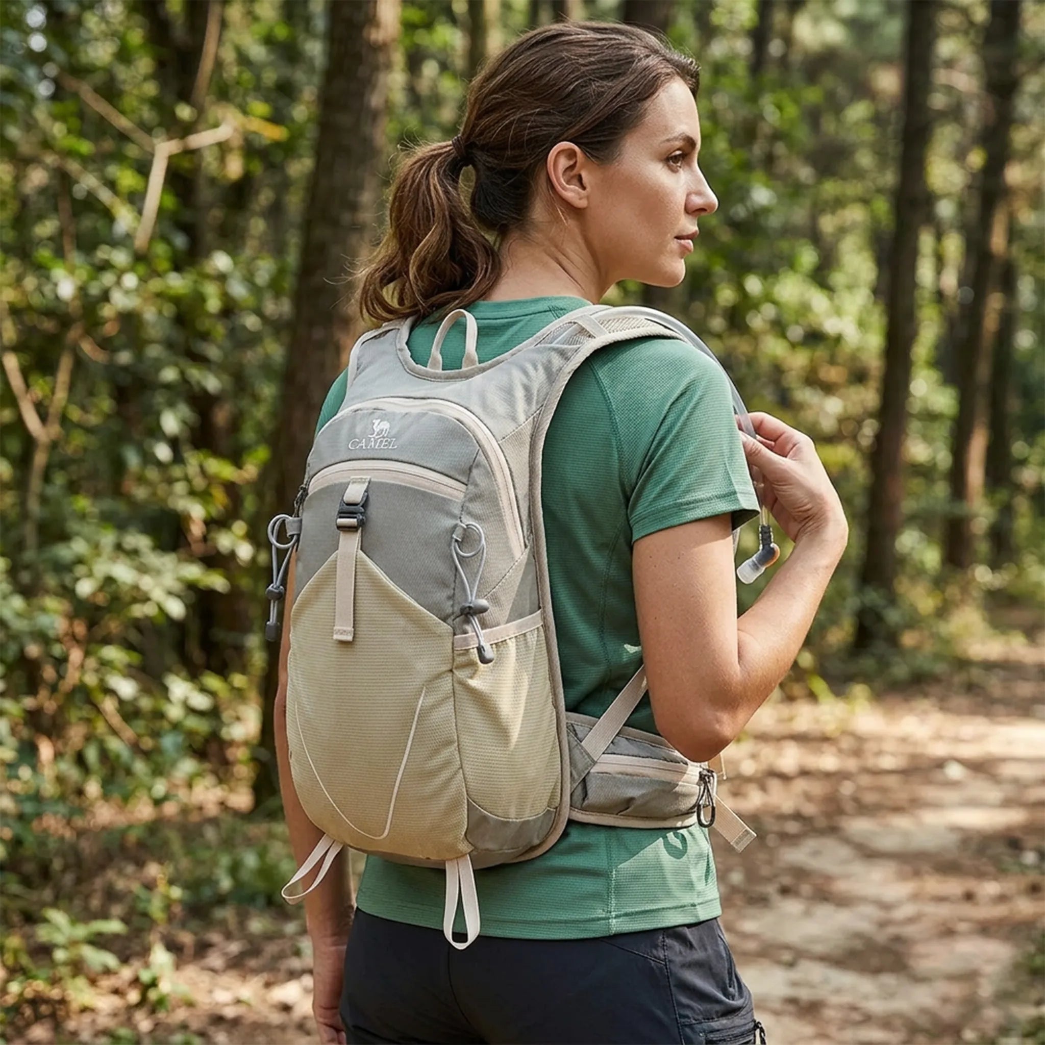 Woman hiking through a forest wearing a Camel 12L hiking backpack in khaki. Lightweight waterproof daypack with breathable shoulder straps, ergonomic fit, and compact 12L storage for hiking, trekking, camping, travel, walking, and outdoor adventures.