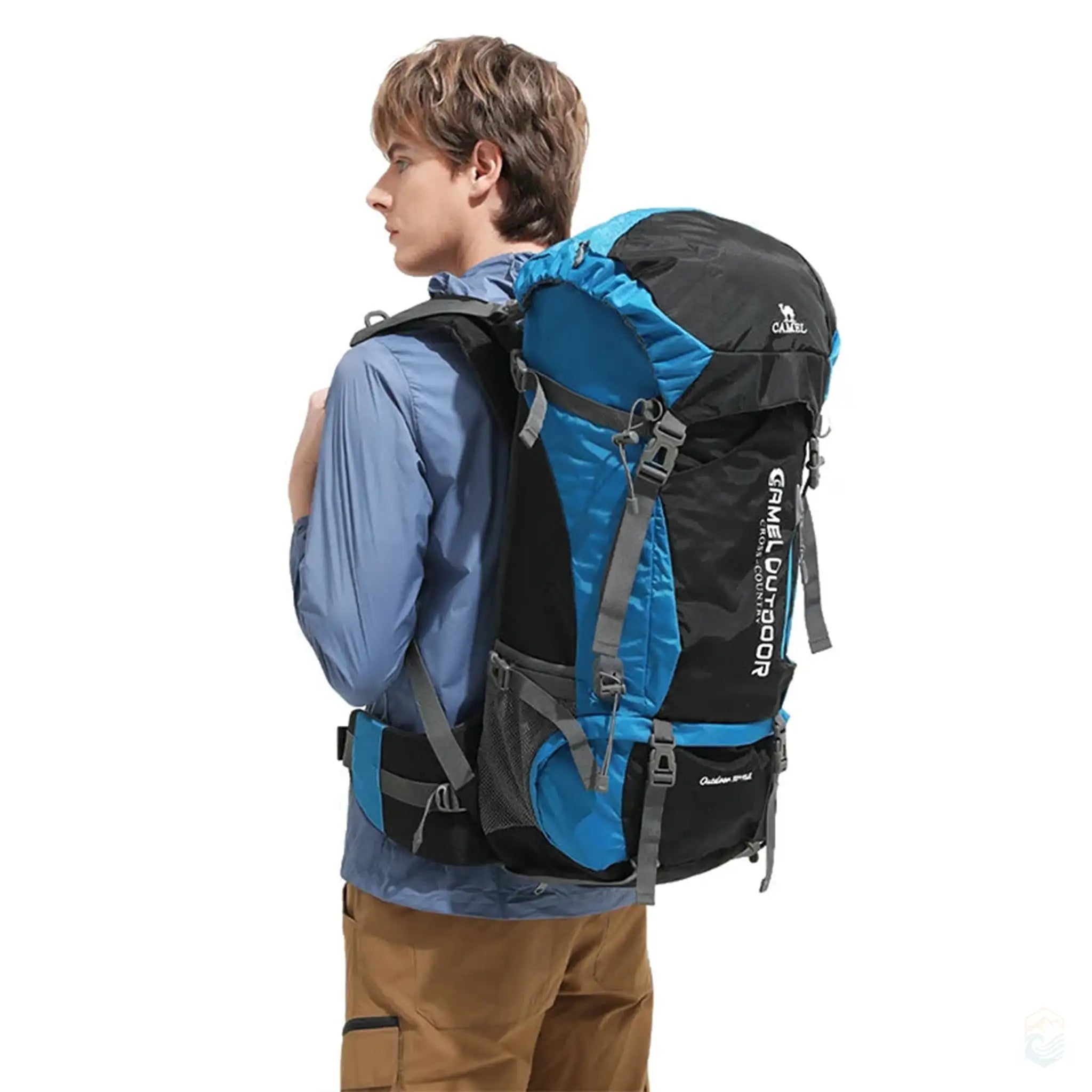 Man wearing Camel 65L hiking backpack in dark aqua, showcasing the backpack's sturdy design and comfortable fit, ideal for outdoor trekking and long hikes.