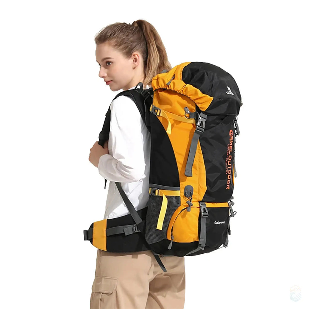 Woman wearing Camel 65L hiking backpack in yellow, demonstrating the backpack's ergonomic fit and adjustable straps, perfect for long-distance hiking and outdoor activities.