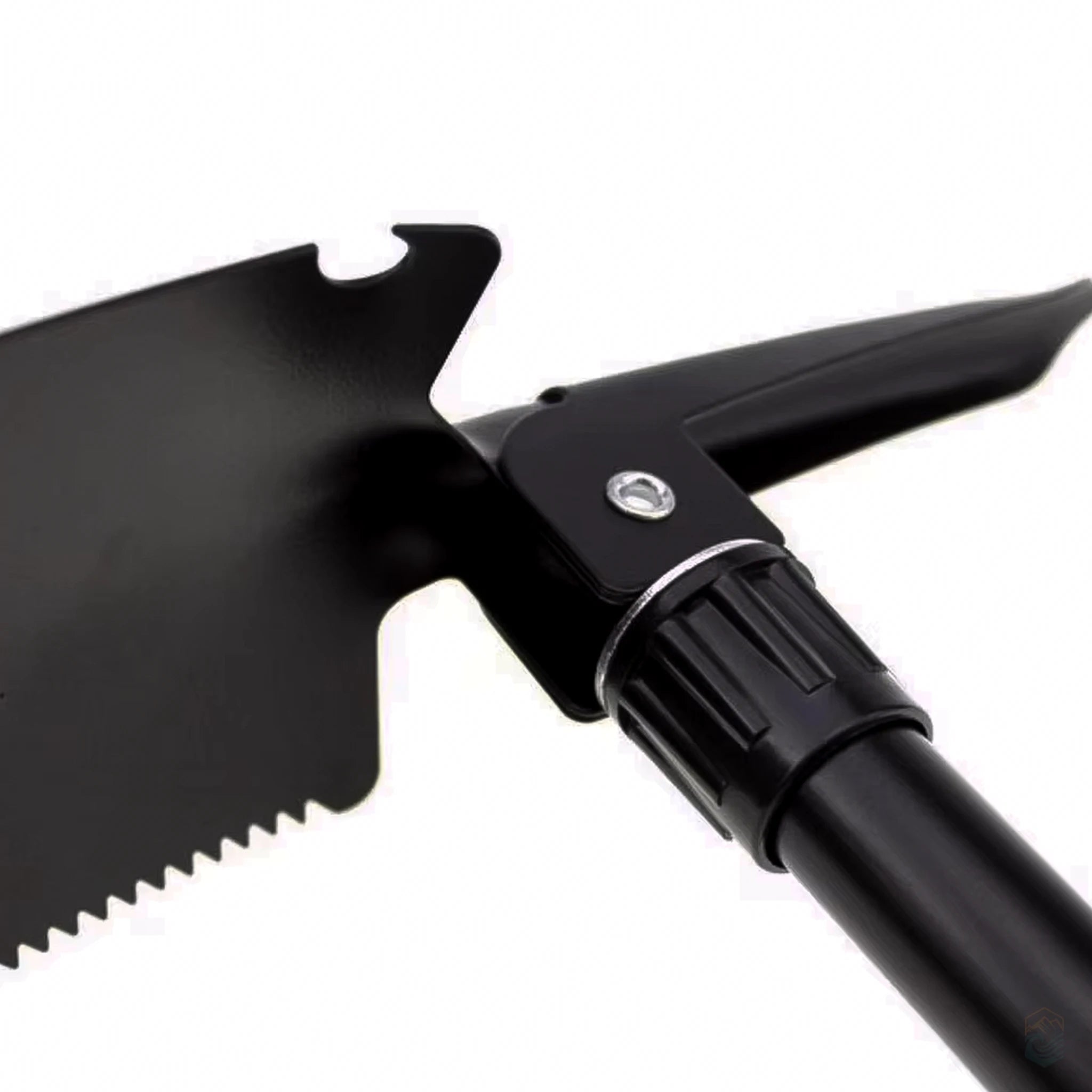 Close-up of black folding survival shovel head featuring serrated edge, integrated bottle opener notch, and pickaxe attachment, designed for rugged outdoor use and versatility
