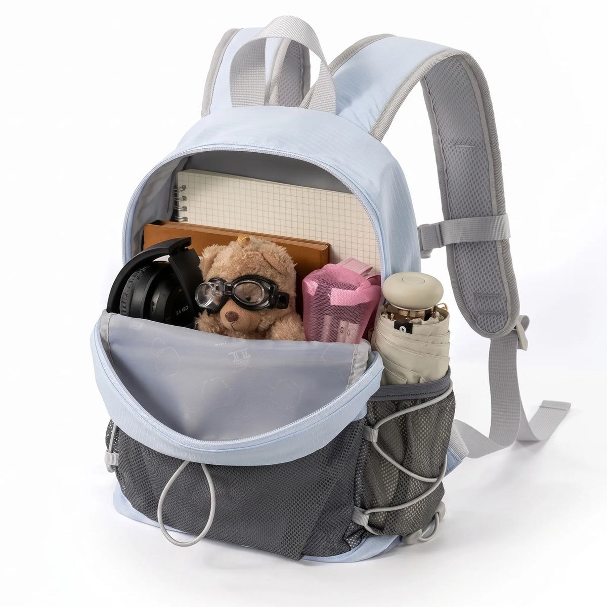 Golden Camel lightweight blue hiking backpack open with notebooks, headphones, accessories, front mesh storage, and side pocket.