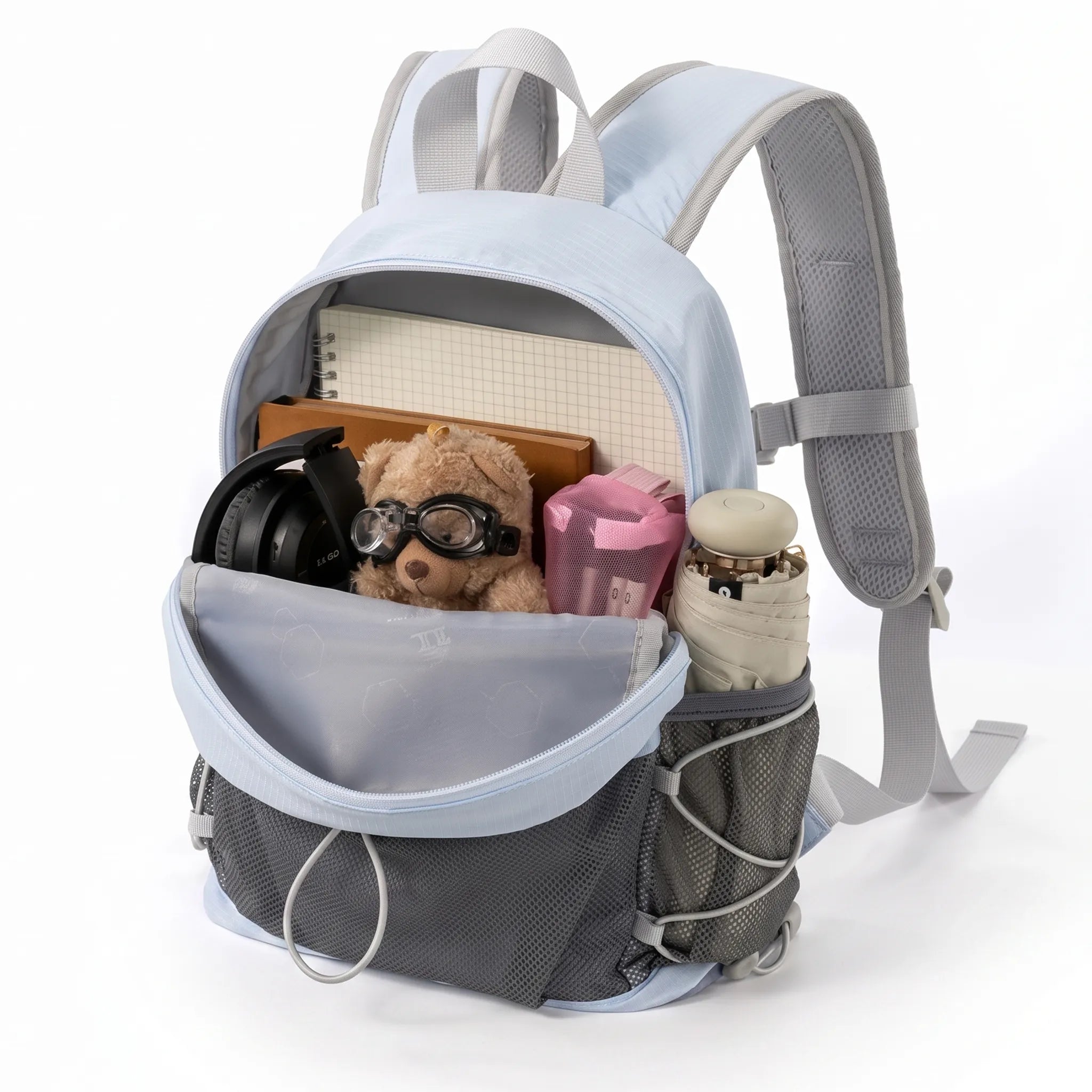 Golden Camel lightweight blue hiking backpack open with notebooks, headphones, accessories, front mesh storage, and side pocket.