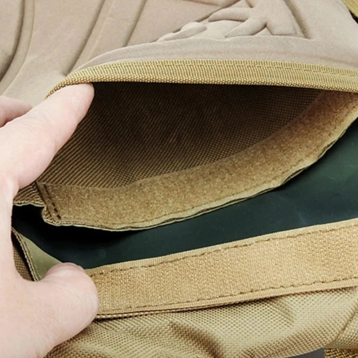 Close-up of the velcro opening on a tactical hydration pack, showcasing the secure closure mechanism for the water bladder compartment.