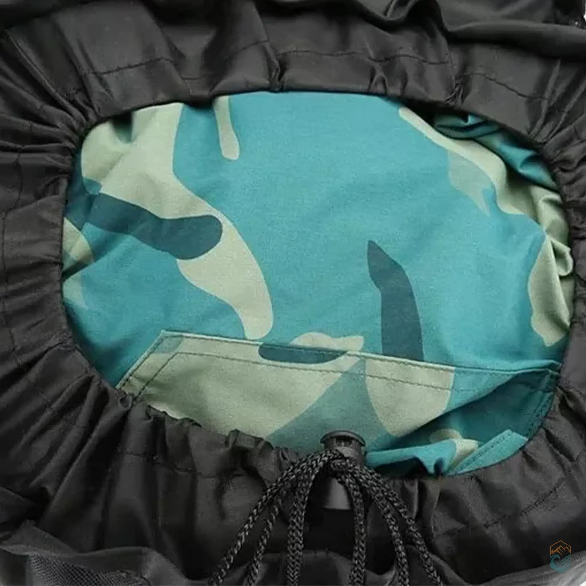 Close-up of the interior storage compartment of a 90L hiking backpack, featuring a camouflage item secured inside, demonstrating the spacious and secure packing capability for extended outdoor adventures.