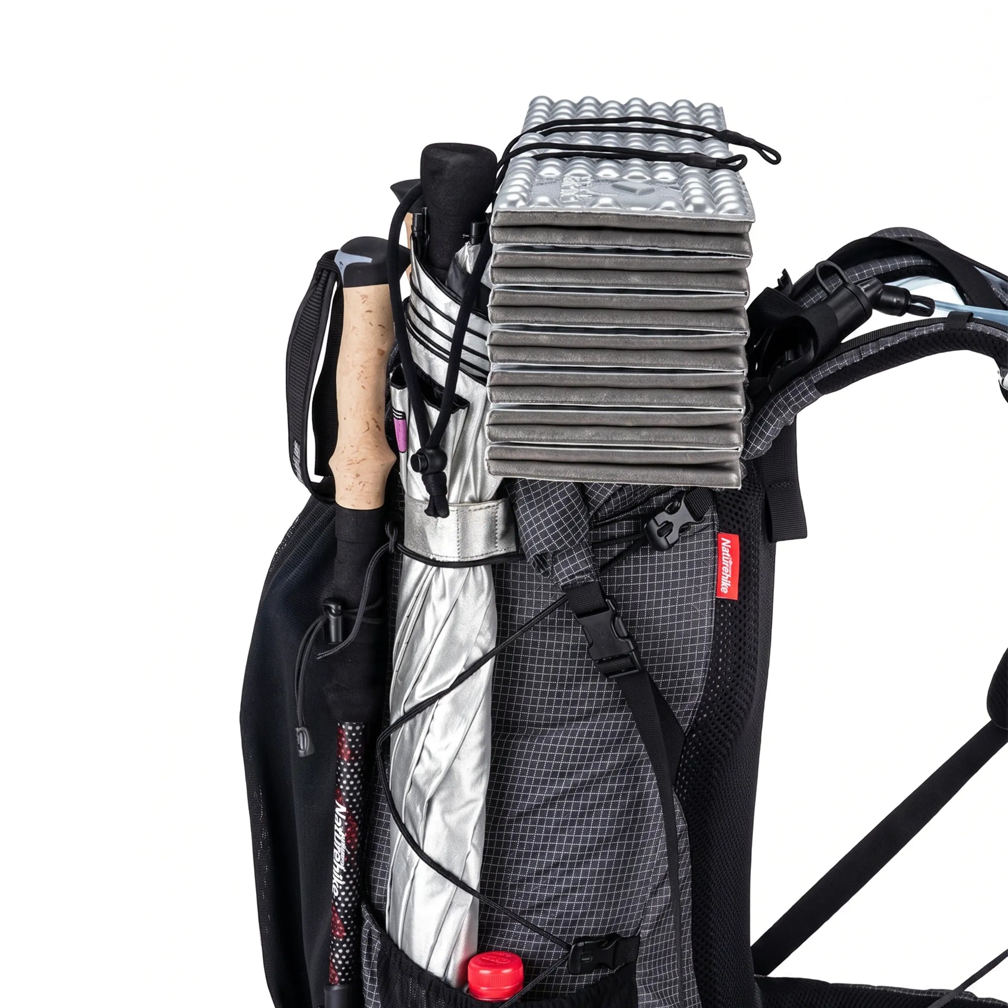 Close-up side view of the Naturehike 60L+5L ultralight hiking backpack showing external attachment points for a foam sleeping pad, trekking pole, umbrella, water bottle, and hiking gear on a white background.