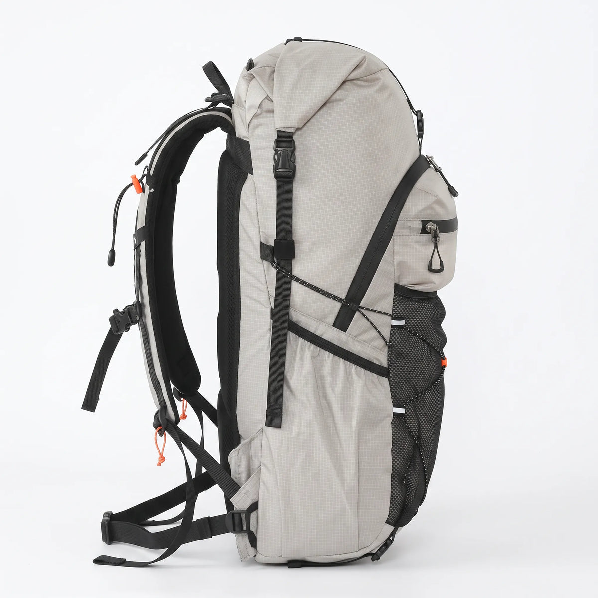 Side view of gray Outdoor Inoxto 25L hiking backpack showing roll-top closure, side storage pocket, compression straps, and padded back support.