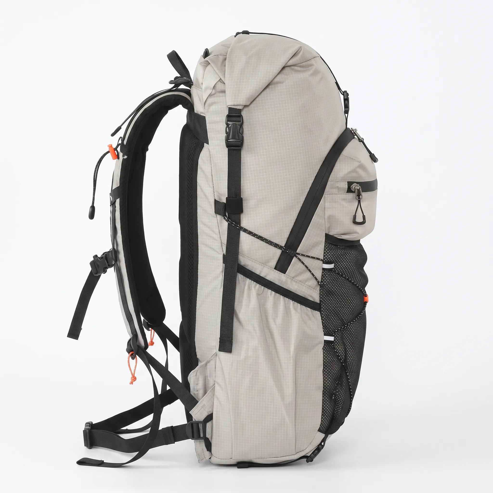 Side view of gray Outdoor Inoxto 25L hiking backpack showing roll-top closure, side storage pocket, compression straps, and padded back support.