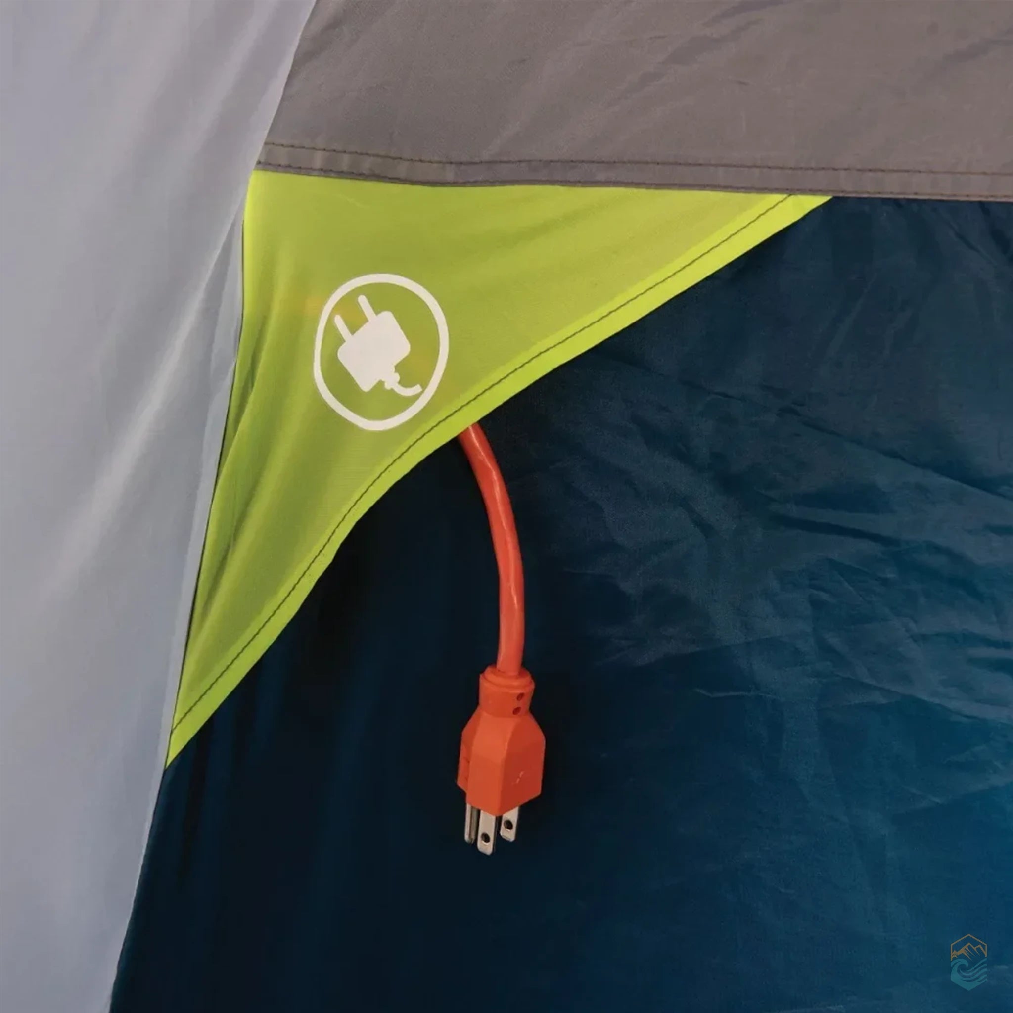 Exterior view of a tent's power cord access port with a bright orange extension cord and plug icon on green fabric panel
