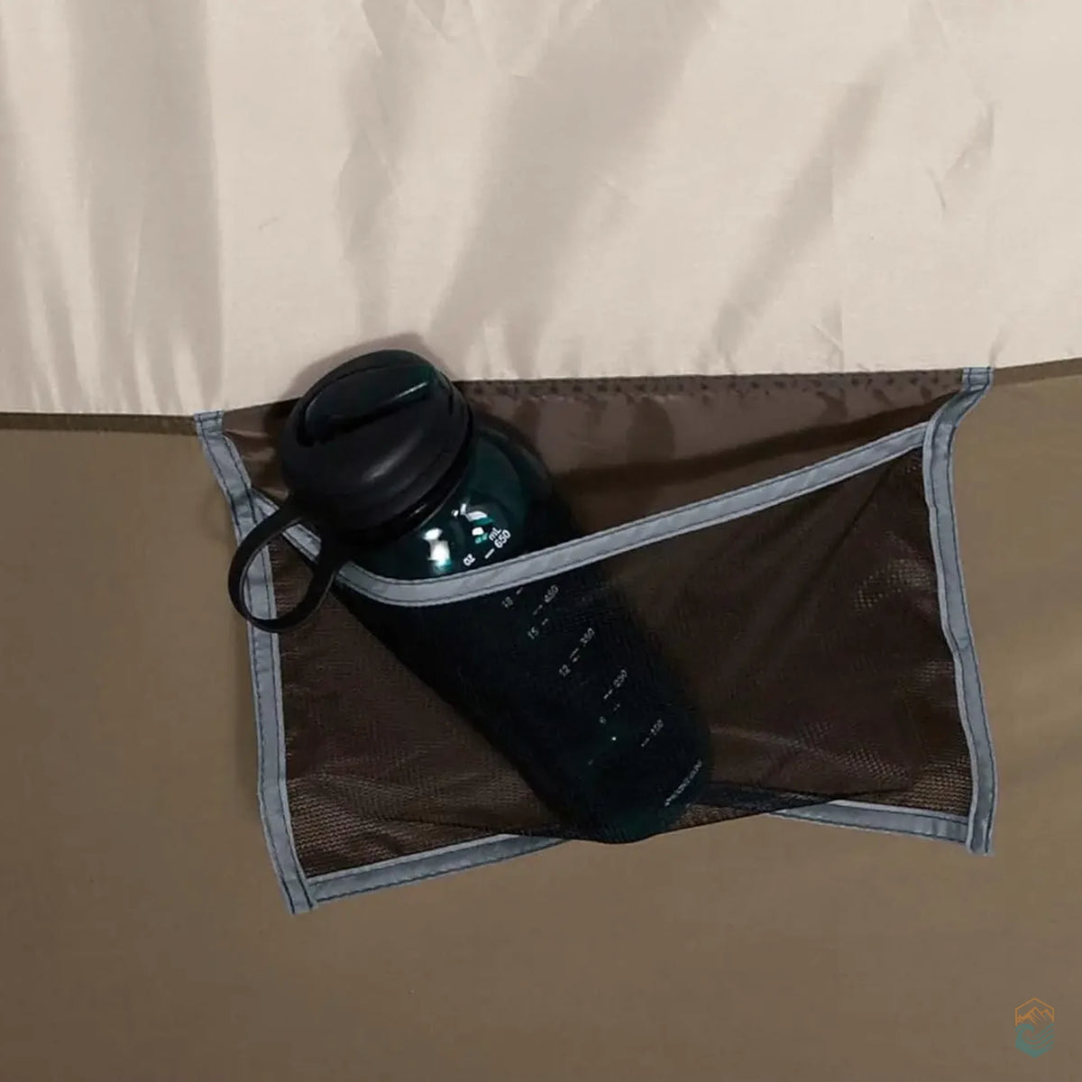 Interior mesh pocket of the Wenzel Klondike tent holding a water bottle, showcasing built-in storage space